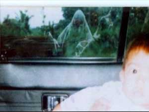 Foto de uma criança dentro de um carro e vultos aparecendo no vidro traseiro